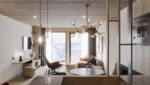 Cozy living room with large windows overlooking a snowy landscape, wood-paneled ceiling, modern chandelier, leather armchair, round coffee table, and a fireplace