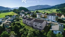 Detached houses with modern design, set in a rural landscape, large windows, solar panels