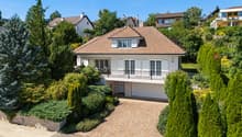 2 story house, brown roof, white walls, balcony, garage, driveway