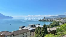 Vue magnifique sur le lac et la ville depuis un appartement lumineux.