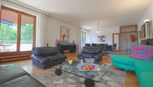 Leather sofas, wooden floor, large windows, balcony, sliding doors, table with fruit