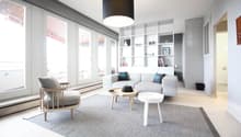ample windows, gray couch, wooden table, floor lamp, wooden chair, carpet