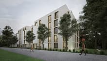 A modern, multi-story apartment building with a clean, minimalist design. The building features large windows and balconies, surrounded by trees and greenery. The exterior is primarily made of light-colored materials, creating a sleek and contemporary loo