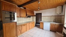 wooden cabinets, stainless steel oven, gas stove, wooden ceiling, white tiles, dishwasher
