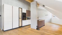 kitchen area with modern cabinets, hardwood floors, and built-in appliances