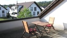 Balcony with table and chairs, view of the houses