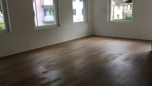 empty room, wooden floor, white walls, three windows, balcony outside