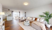 Living room with beige couch, white coffee table, white rug, and beige armchairs