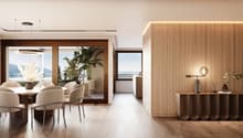Dining room with wooden floor, large windows, dining table, chairs, wooden wall, artwork, plants