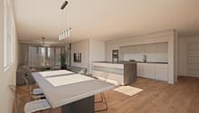 The image shows an open concept living room and kitchen area. The kitchen features modern, light-colored cabinets and a large island with a stone countertop. The living room has a large window that provides access to a balcony or terrace. The space has a