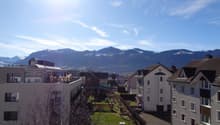 The exterior view of buildings with a beautiful mountain backdrop.