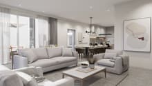 Spacious open-concept living room and dining area, with large windows, grey sofas, coffee table, and modern artwork on the wall. The kitchen is visible in the background, with a dining table and chairs. The space has a clean, minimalist design with neutra