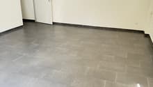 empty room, white walls, gray tiles, white doors, power outlet