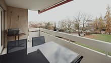 Balcony with table and chairs, covered balcony, grassy area