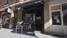 Two restaurants, one has a blackboard menu on the entrance