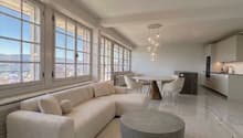 modern living room, white couch, round table, chandelier, marble floor, large windows, dining table, kitchen
