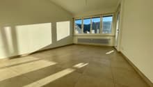 empty room with tiled floor, white walls, window, radiator