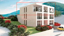 Modern multistory apartment building, white exterior, multiple balconies, car park area