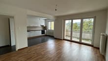 empty room, wooden floor, white walls, kitchen with appliances, sliding glass doors to balcony, radiator