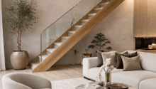 large lounge sofa, modern rug, circular coffee table, wood stairs, two pendant lights
