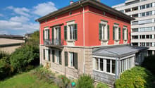 3 story house, red exterior, white windows, balcony, glass conservatory, garden