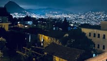 House in neighborhood, balcony, distant mountain and city lights, night view
