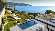Modern villa with swimming pool, sea view, outdoor lounge area, green lawn, white lounge chairs, black railings, white walls, green plants, round table, potted plant, black lamp