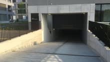 Parking lot for guests, entrance to the building, concrete walls, underground parking, iron railings, sign indicating the height restriction