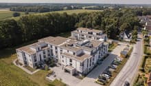 2 story apartment building, white exterior, multiple windows, parking lot, multiple cars parked