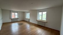 empty room, wooden floor, white walls, three windows, radiators