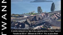 Aerial view of village, houses, restaurant, buildings, water body, mountains, greenery, train tracks