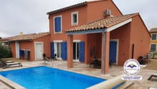 Two-story Mediterranean-style house with red tile roof, blue shutters, and a swimming pool in the backyard. The house has a covered patio area with outdoor furniture.