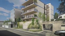 Modern multi-story building with balconies, wall greening, and garages.