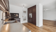 kitchen, modern design, wooden floor, stainless steel countertop, integrated oven, wooden cabinets, large sink, faucet