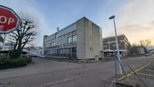 4 story office building, grey color, glass windows, parking lot, trees, street light
