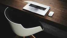wooden desk, white chair, laptop, mouse