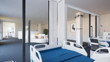 The image shows a modern and spacious hospital room with a comfortable-looking bed, white curtains, and various medical equipment such as an IV stand and a monitor. The room has large windows that provide natural light and a view, suggesting the presence