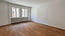 empty room, wooden floor, white walls, windows, radiator