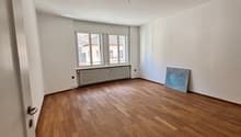 empty room, wooden floor, white walls, windows, radiator