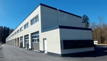 modern building, multiple garages, white exterior, glass windows, number 22 on the wall