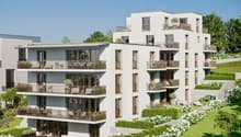 Modern apartment building with multiple balconies, landscaped garden, and green surroundings