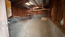 empty room, concrete floor, wooden ceiling, wooden shelves, metal ladder, small storage box