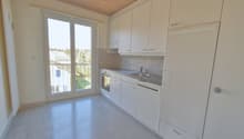 Empty kitchen with modern fittings, large window, dishwasher, washing machine, oven.