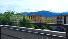 Terrace with metal railing, panoramic view, mountains in the background