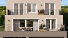 2-story modern house with a beige exterior, large windows, balconies, and a garage on the ground floor.