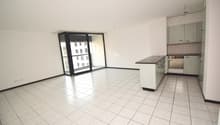 white tile flooring, glass sliding door, balcony, modern white cabinets, central island, stainless steel counter