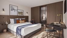 Wooden floor, large bed, bedhead with cabinets, desk, chair, lamps, table