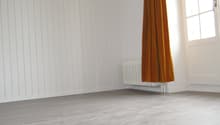 empty room, white walls, wooden floor, white radiator, window with white frame
