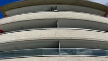 modern design, multiple balconies, curved walls, concrete and glass