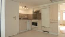 modern kitchen with white appliances, granite countertops, wooden cabinets, tiled floor